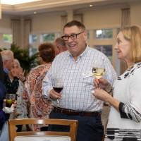 William and Jean Suggs talking with other guest at event